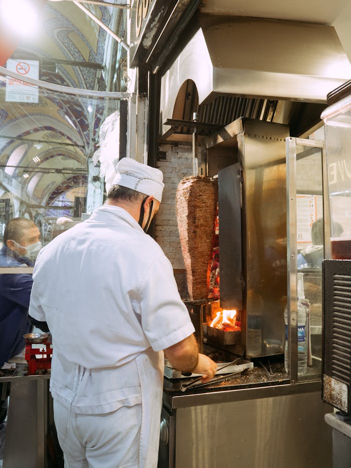 Chef prepares authentic döner kebab in Istanbuls iconic marketplace.